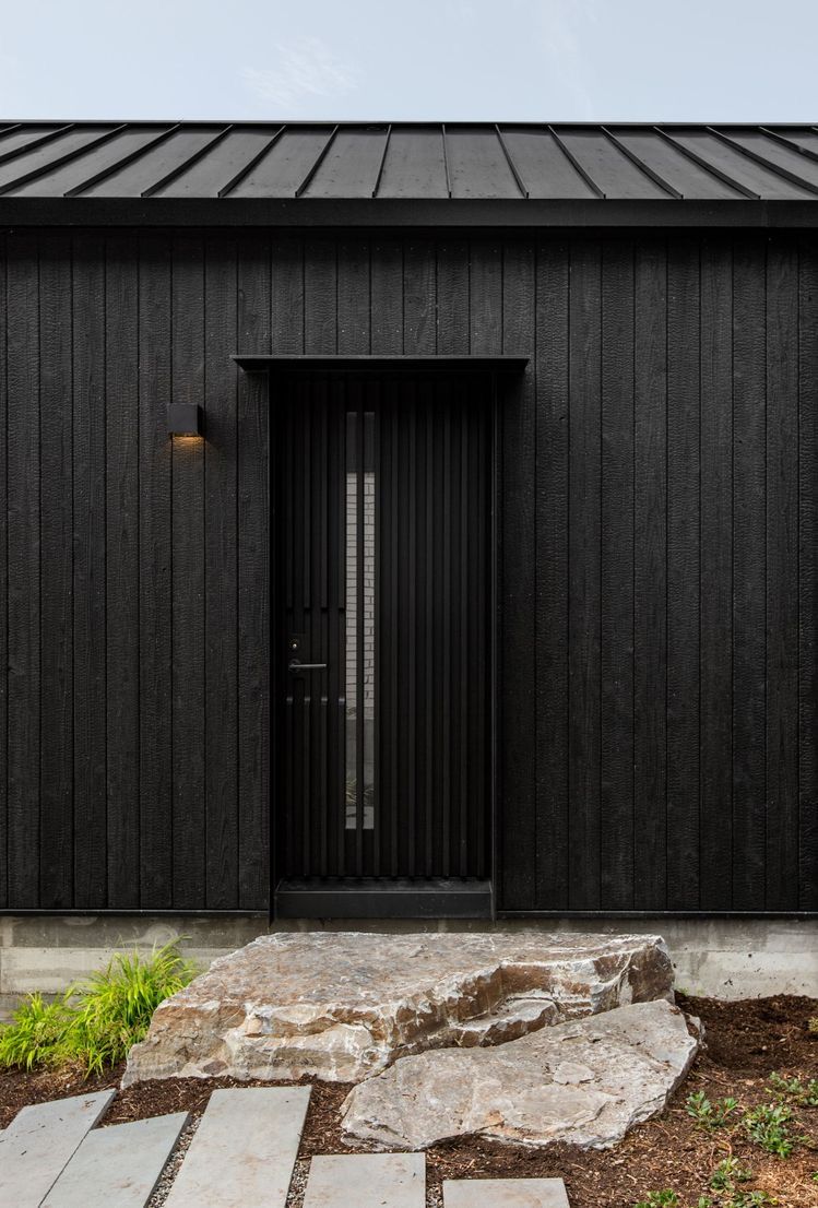 Black charred timber shadow gap cladding on UK contemporary house exterior