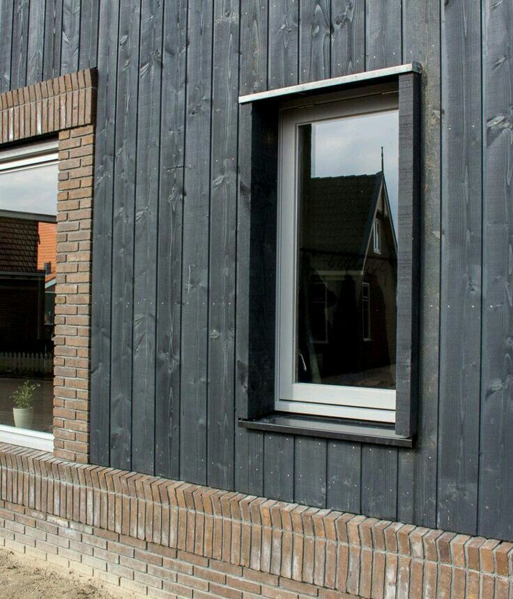 Modern timber cladding house with vertical wood façade and large glazing