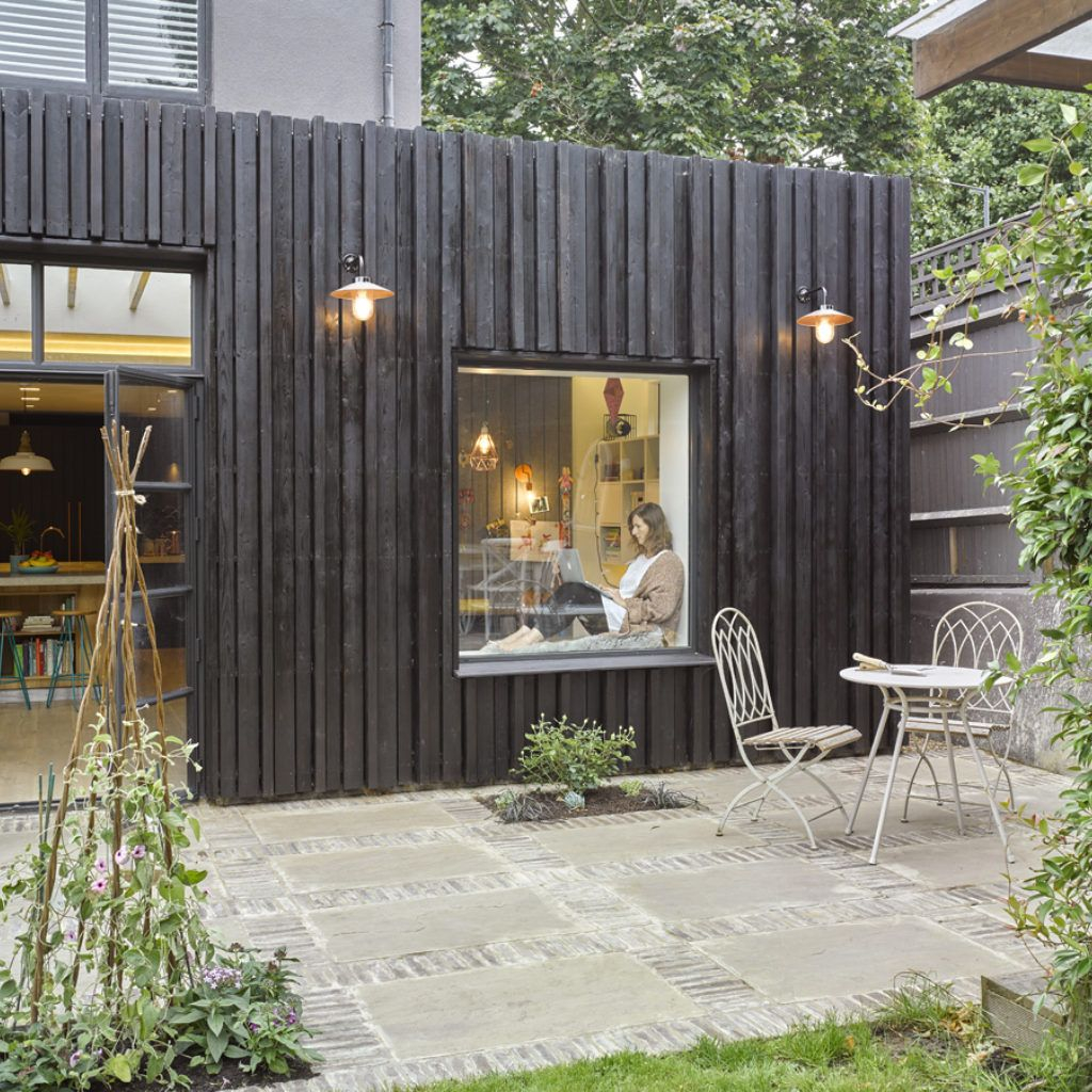 Charred timber cladding on UK garden office with mixed material detailing — contemporary exterior