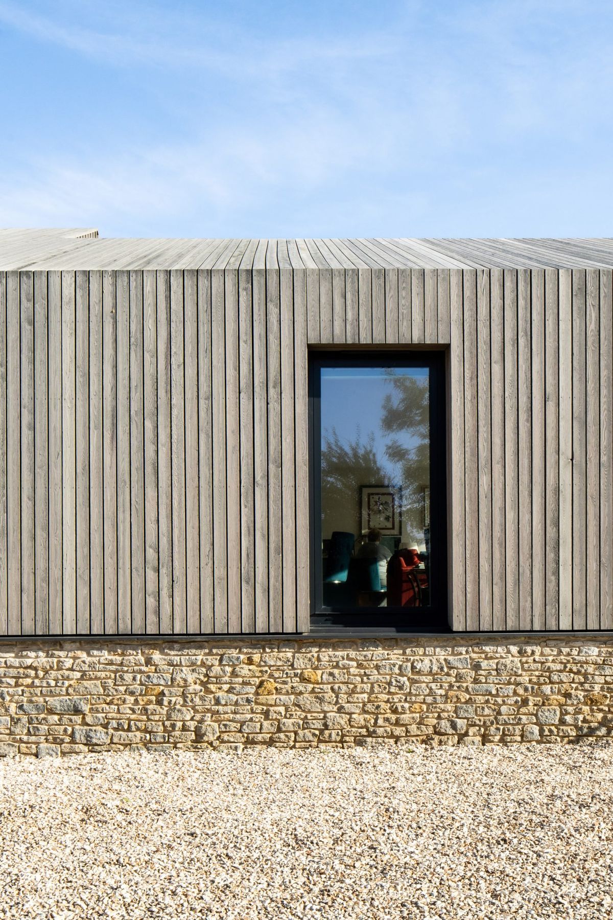 Modern timber cladding on UK house with vertical boards and natural wood facade