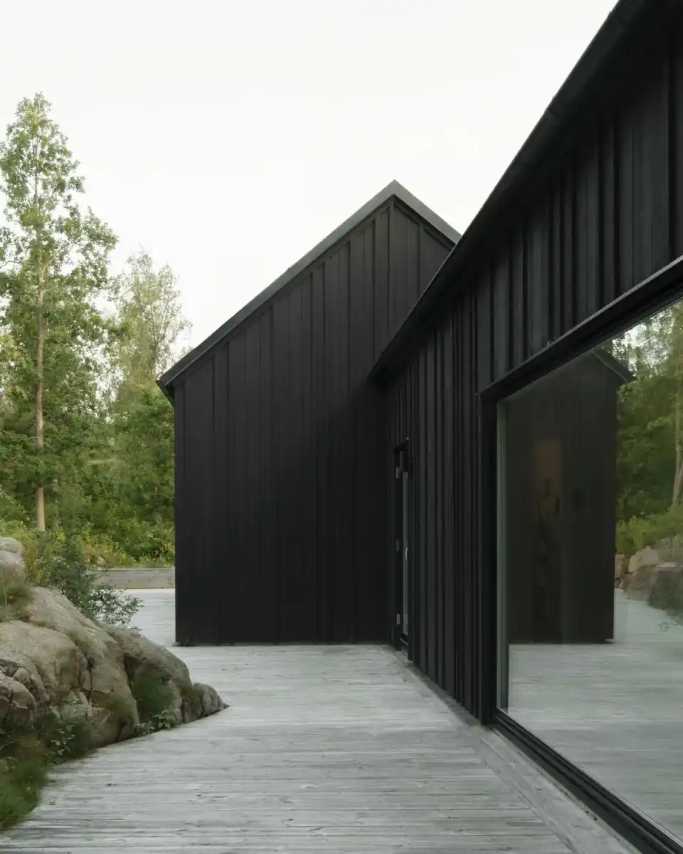Black timber cladding on contemporary UK house — charred or stained dark exterior finish