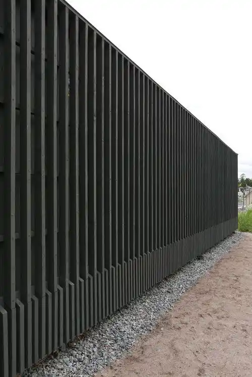 Black charred timber fencing installed in UK garden — vertical fence boards with steel posts