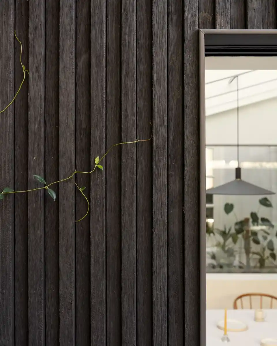 Charred brushed and stained timber cladding boards showing different finish levels