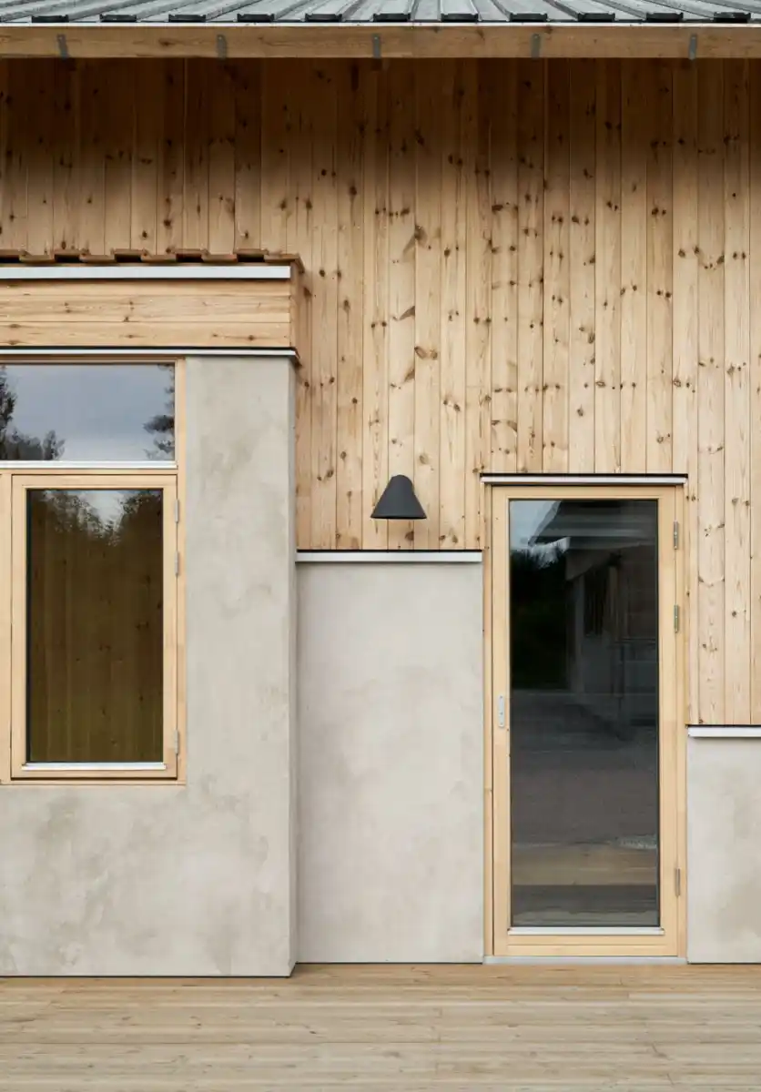 Cladding and render on house UK — timber cladding replacing render on residential building