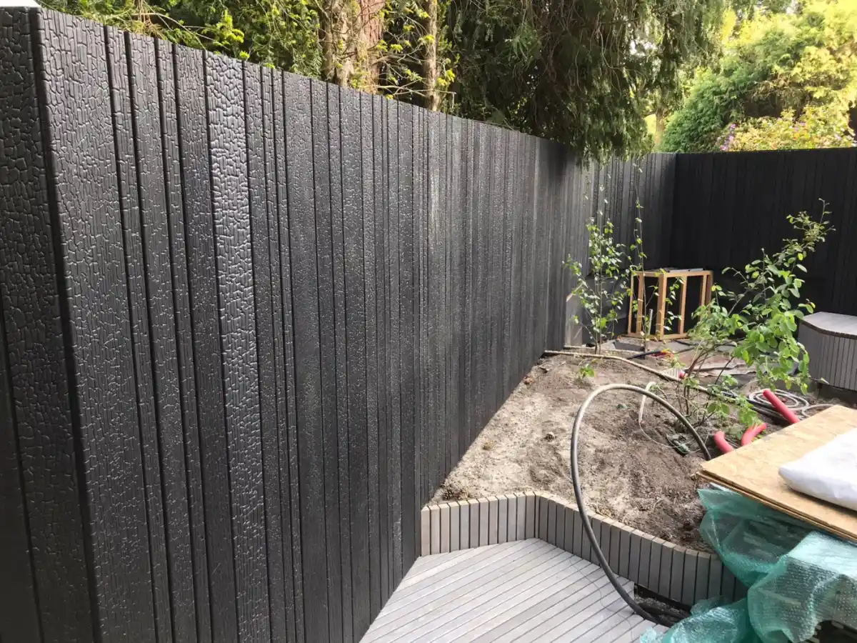 Deep charred fence boards UK — close up of heavily carbonised timber surface