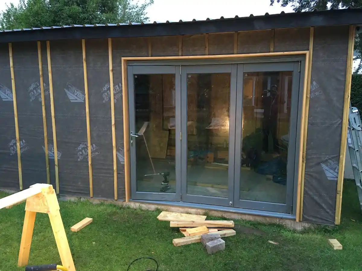 Garden room membrane and battens UK — vertical counter battens creating ventilated cavity behind cladding