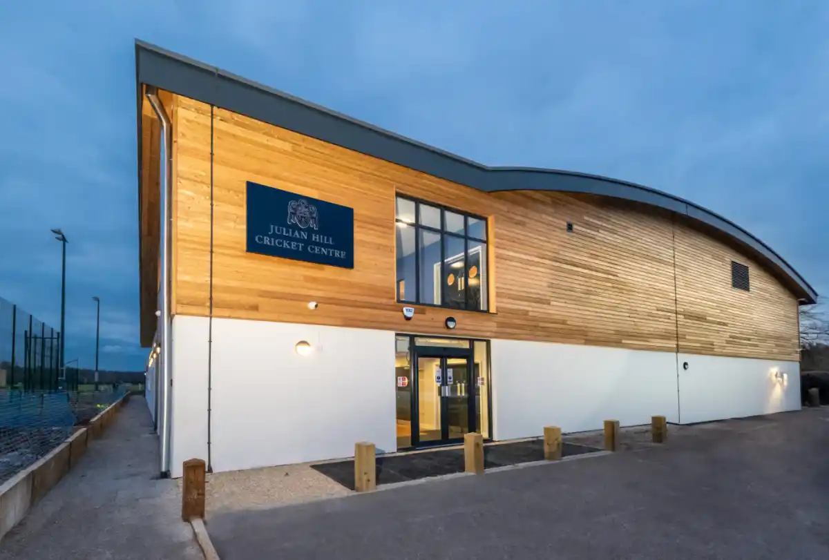 Merchant Taylors' School Julian Hill Cricket Centre timber cladding — Siberian larch shadow gap exterior