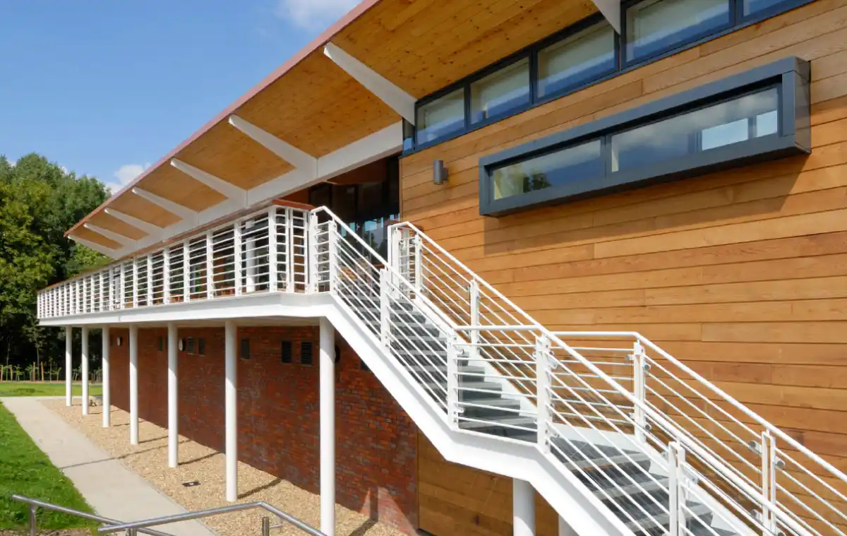 Timber cladding for schools UK — Merchant Taylors School sports and cricket pavilion Siberian larch exterior