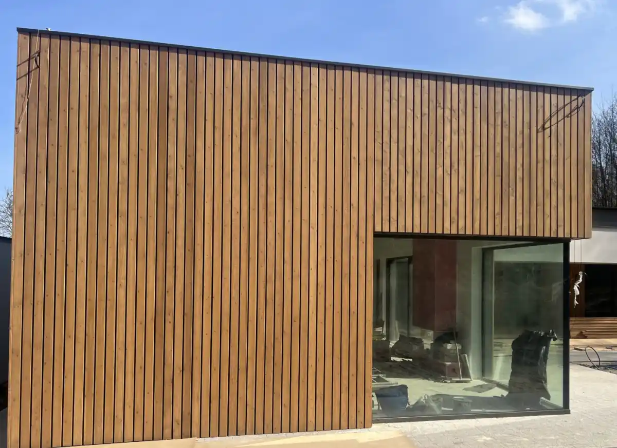 Nordic spruce external cladding on UK house — shadow gap profile timber cladding elevation