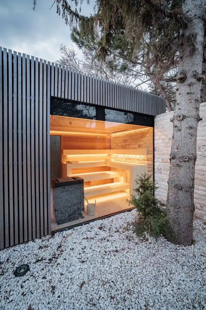 Outdoor garden sauna exterior with weathered timber cladding — UK residential project
