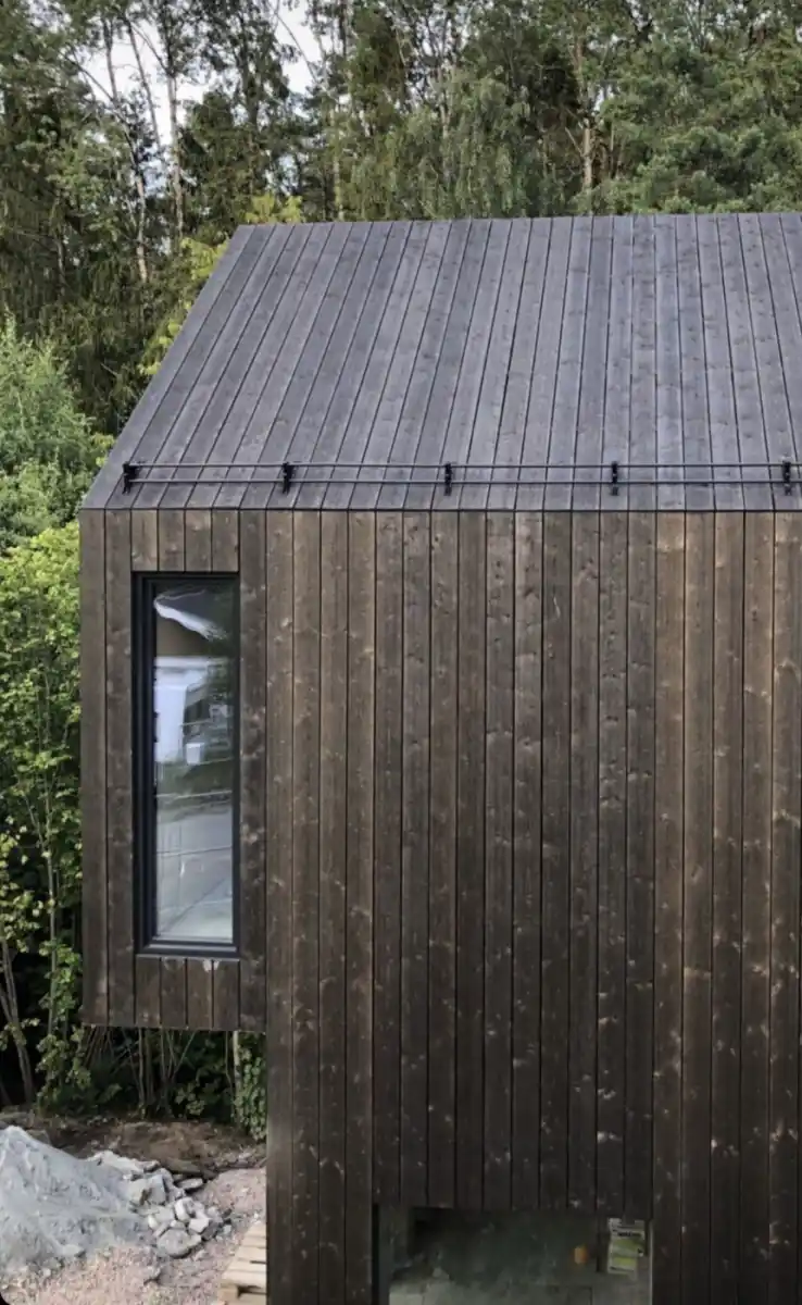 ThermoWood cladding weathered on UK house — silver-grey natural patina zero maintenance