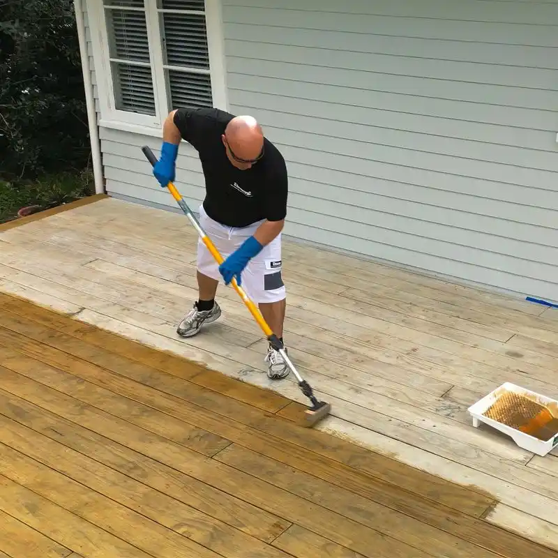 Oiling timber decking UK — applying decking oil to wooden deck boards after cleaning