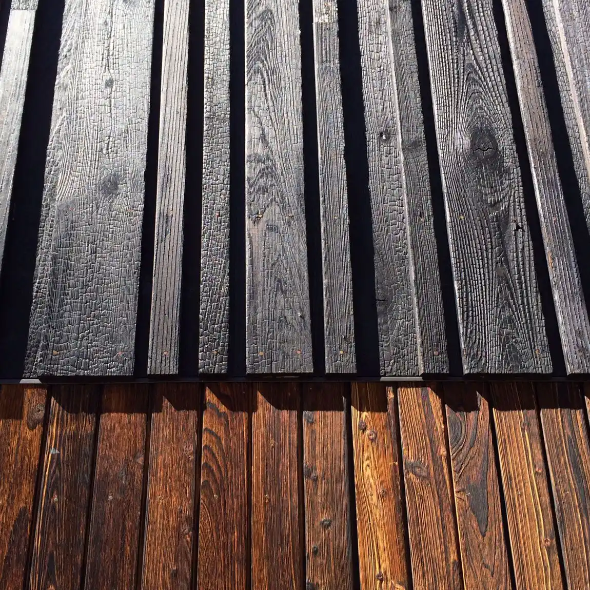Natural timber grain cladding close-up — real wood texture and warmth that composite cannot replicate