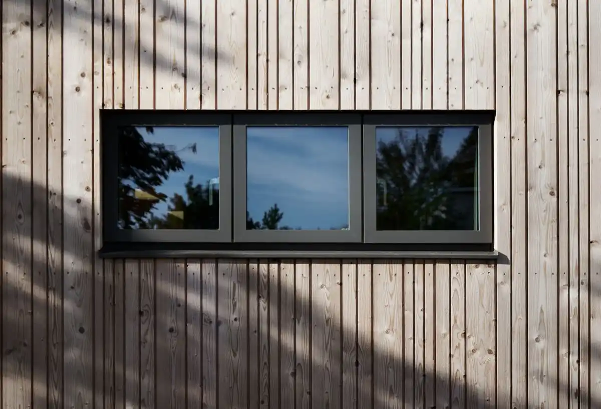 Vertical shadow gap timber cladding on UK house — contemporary exterior rainscreen installation