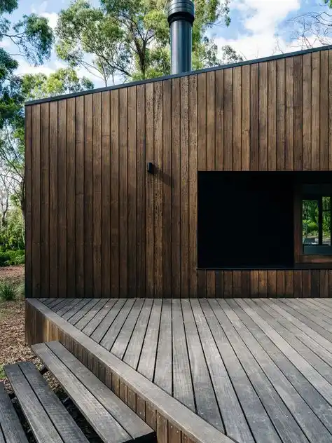 Vertical timber cladding on contemporary UK house — upright profile exterior facade