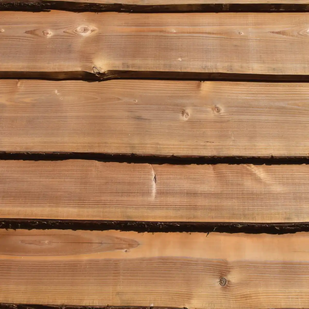 Waney edge larch weatherboarding UK — natural live edge rustic cladding exterior