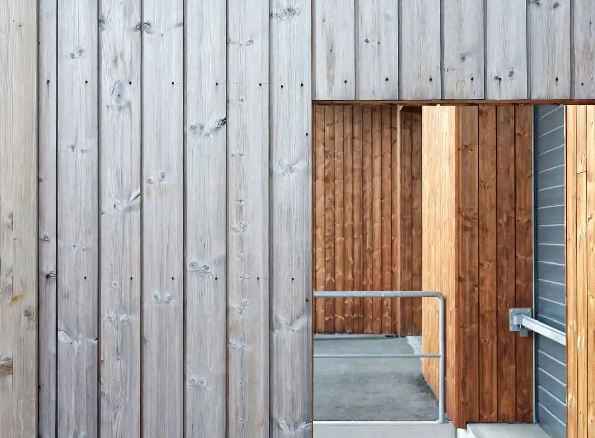 Weathered shiplap vertical cladding UK — natural silver-grey patina on garden building exterior