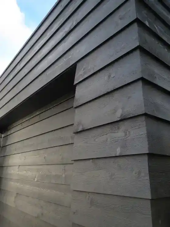 Black feather edge cladding UK — dark stained rebated featheredge boards on contemporary building