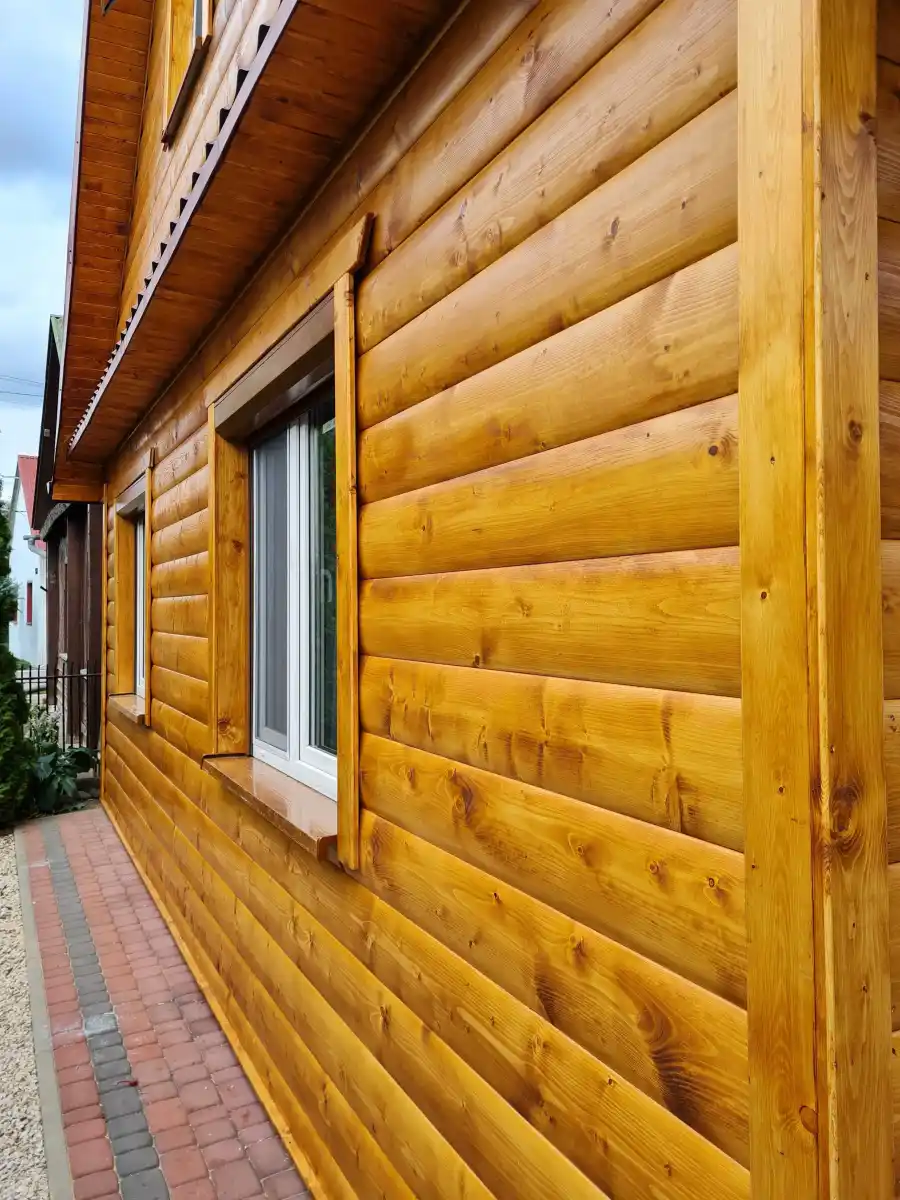 Loglap cladding detail UK — rounded convex profile timber boards on exterior wall