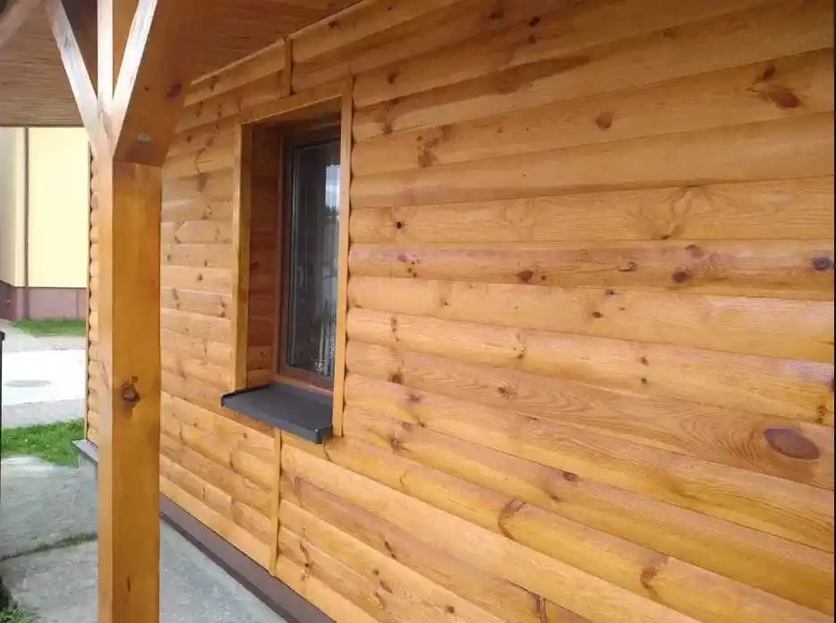 Loglap cladding on garden building UK — horizontal rounded timber boards on exterior wall
