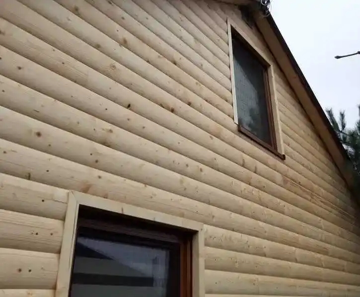 Loglap timber cladding installation UK — horizontal boards being installed bottom to top