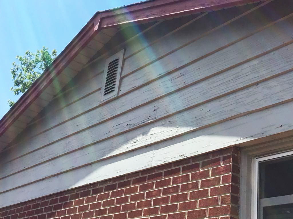 Cracked paint and movement damage on poorly specified timber cladding
