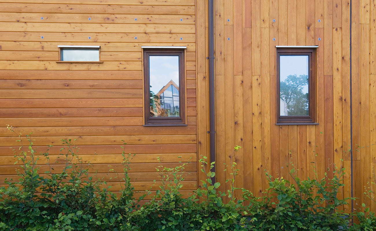 Comparison of vertical and horizontal timber cladding on modern UK house exterior